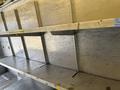 A 2012 Ford Econoline with a spacious interior featuring metal shelving and storage compartments designed for utility use