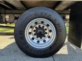 A close-up of a Goodyear G372 LHD tire mounted on a silver wheel with multiple lug nuts visible