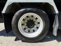 Close-up of a silver wheel with a black tire labeled 225701225 mounted on a 2019 Peterbilt 337 truck