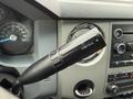 Close-up of the gearshift lever in a 2015 Ford F-450 showing the Tow/Haul button on the side