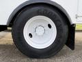 A close-up of a black Goodyear tire mounted on a white rim designed for a 2013 International Durastar 4300 vehicle