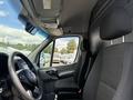 Interior view of a 2016 Mercedes-Benz Sprinter with two black fabric seats and dashboard visible in the foreground