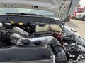 A close-up view of the engine compartment of a 2014 Ford F-250 SD showcasing various components including hoses and reservoir tank