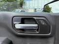 Close-up of the door handle and control buttons for locks and windows on the interior of a 2019 Chevrolet Silverado 1500