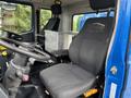 Interior of a 2017 Autocar Xpert showing the driver's seat and steering wheel with controls and a metal storage box nearby