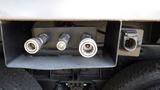 Close-up of three connectors on a 2003 International 5600i truck chassis with the fourth connector partially visible to the right