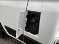 Close-up of the fuel door on a 2023 RAM Promaster 3500 with the cover open revealing the fuel filler neck inside