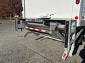 A 2022 Lion Lion6 liftgate is mounted at the rear of a truck featuring a dual-bar design with a retractable mechanism and safety features including reflectors