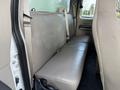 Interior view of a 2008 Ford F-450 rear bench seat with beige upholstery and a seatbelt visible