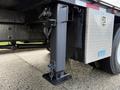 Detail of a 2010 International 4300 trailer hitch showing a sturdy metal support structure and a secured safety chain