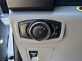 A control knob in a vehicle featuring settings for headlights fog lights and instrument panel brightness
