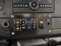 The control panel of a 2019 Chevrolet Express featuring multiple buttons for various functions including open doors deploy ramp and adjust interior lights