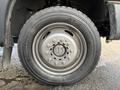 Close-up of a wheel from a 2015 Ford F-550 featuring a metallic rim and tire with a rugged tread pattern