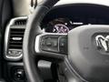 Steering wheel of a 2024 RAM 5500 with control buttons for navigation and settings