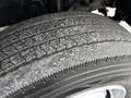 Close-up of a used tire from a 2019 Hino 195 showing worn tread and dust accumulation on the surface