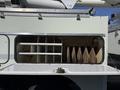 A 2008 International 7500 with an open compartment revealing wooden blocks and metal shelves inside