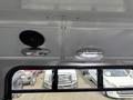 View of the ceiling interior of a 2018 Chevrolet Express showing two interior lights and a speaker mounted on the ceiling