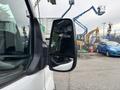 A 2020 Ford Transit 250 with a clear view of the side mirror reflecting the surroundings
