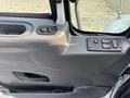 The interior door panel of a 2012 International DuraStar 4300 featuring control buttons for windows and locks