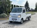 A 2008 Suzuki Carry truck with a white exterior featuring a flatbed design and a compact cab positioned at the front