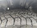 Close-up of a rugged tire tread on a 2016 RAM 1500 showing deep grooves and wear patterns