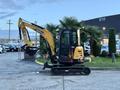 A yellow 2023 Sany SY35U mini excavator with a black tracked undercarriage and a hydraulic arm is positioned, ready for operation