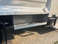 A 2009 Ford F-550 with a grey storage compartment mounted on its side
