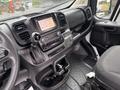 Interior view of a 2023 RAM Promaster 3500 featuring a dashboard with a touchscreen display gear shifter and a driver's seat