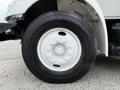 A close-up of a white wheel on a 2006 International 4300 featuring a six-bolt pattern and a black tire with visible tread details