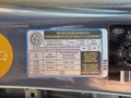 A tire and loading information label attached to the inside of a car door detailing specifications for seating capacity tire pressure and dimensions for a 2018 Kia Rio5