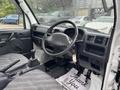 Interior view of a 2008 Suzuki Carry showing the steering wheel gear stick and dashboard with controls