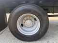 Close-up of a 2012 Hino 338 wheel with a silver rim and black tire displaying the brand name and tire specifications