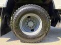 A close-up of a Goodyear Armor Max ESD tire mounted on a silver wheel from a 2009 International 3000 CE bus