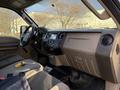 Interior of a 2010 Ford F-550 featuring a driver's seat dashboard with controls and a display screen