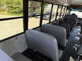 Interior view of a 2011 Freightliner B2 school bus showing gray seats arranged in rows with a clear aisle in between