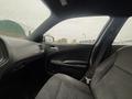 Interior view of a 2017 Dodge Charger showing the driver's seat and dashboard with rain on the windows