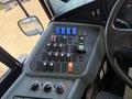 The interior dashboard of a 2013 International CE300 bus featuring various switches buttons and controls for operating the vehicle