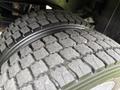 Close-up of a tire from a 2020 Ford F-550 showcasing its rugged tread pattern and design