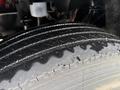Close-up of a wet tire on a 2011 Ford F-650 showcasing the tread pattern and texture of the rubber