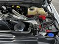 A 2017 Ford F-550 engine compartment featuring various components like pipes a coolant reservoir and battery connections among others