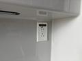 A wall-mounted electrical outlet with two standard power outlets and a USB port