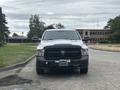 A 2016 RAM 1500 pickup truck facing forward with a distinctive black grille and front bumper mounted accessories