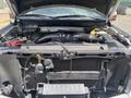 A 2014 Ford F-150 with its hood lifted revealing the engine compartment showcasing various mechanical components and the engine itself