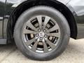 Close-up of a black alloy wheel from a 2014 Honda Odyssey featuring five spokes and the Honda emblem in the center