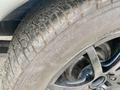 A close-up of a tire showing detailed tread patterns and a black alloy wheel of a 1968 Ford Mustang Two Door Convertible