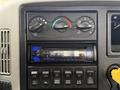 Dashboard of a 2013 International Workstar 7500 featuring air conditioning controls and a car stereo display with the message NO DEVICE