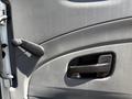 Close-up of the door handle and door lock mechanism of a 2011 International 4300 with a textured surface and a lever handle