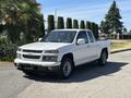 A white 2011 Chevrolet Colorado pickup truck with a regular cab and a short bed