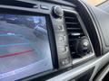 Interior console of a 2018 Toyota Highlander featuring a display screen control panel with buttons for tuning and volume