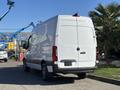 A white 2021 Mercedes-Benz Sprinter 2500 van viewed from the rear with a high roof and large cargo space